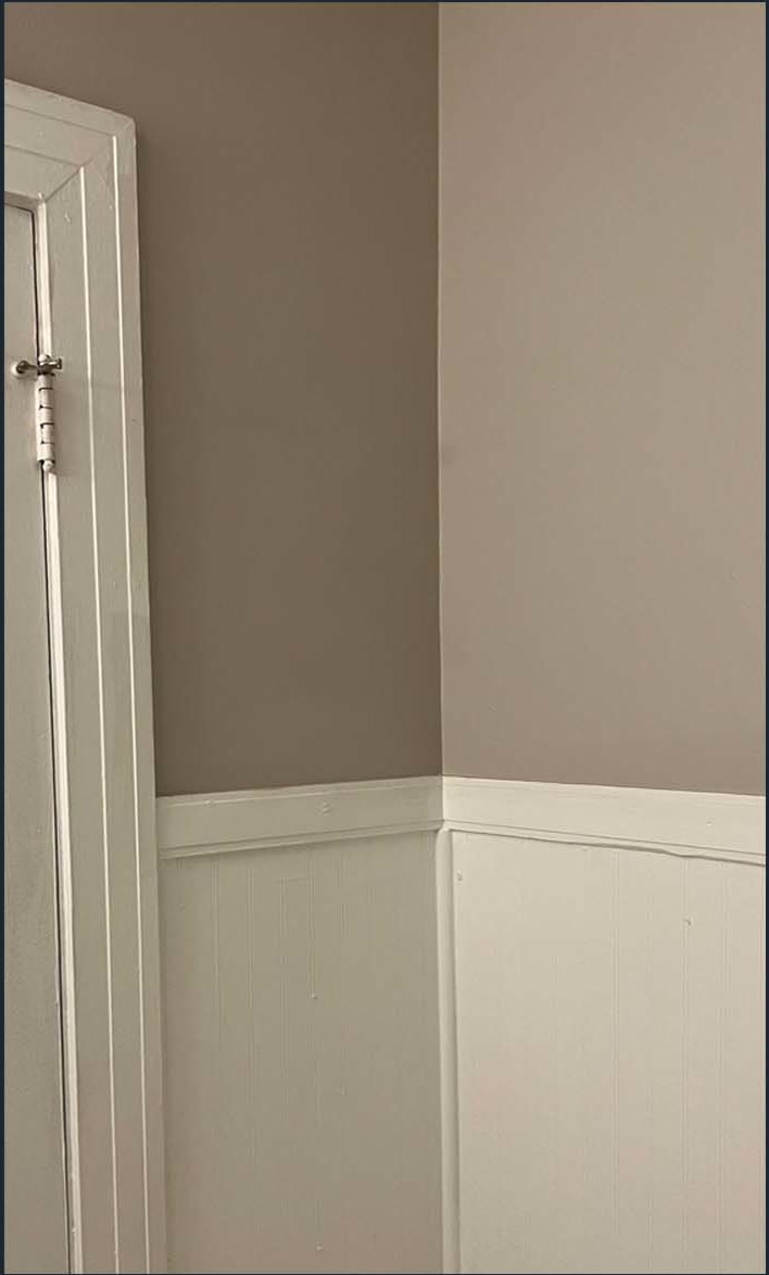 Painted interior wall with white wainscoting and trim